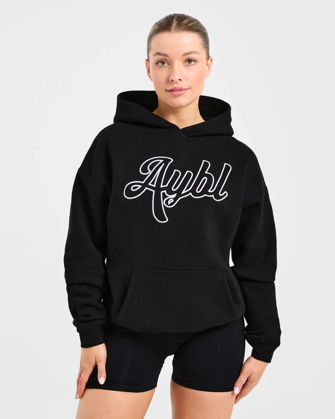 Sweat à capuche oversize avec inscription brodée