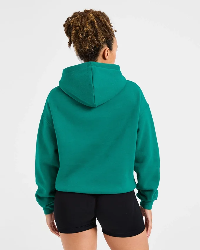 Sweat à capuche oversize avec inscription brodée