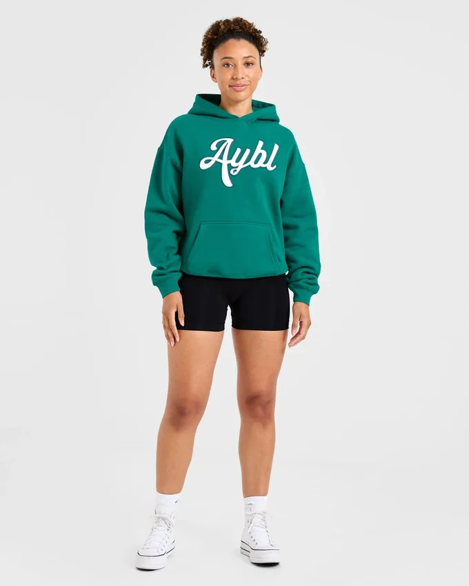 Sweat à capuche oversize avec inscription brodée