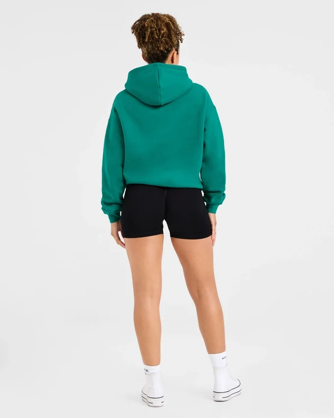 Sweat à capuche oversize avec inscription brodée