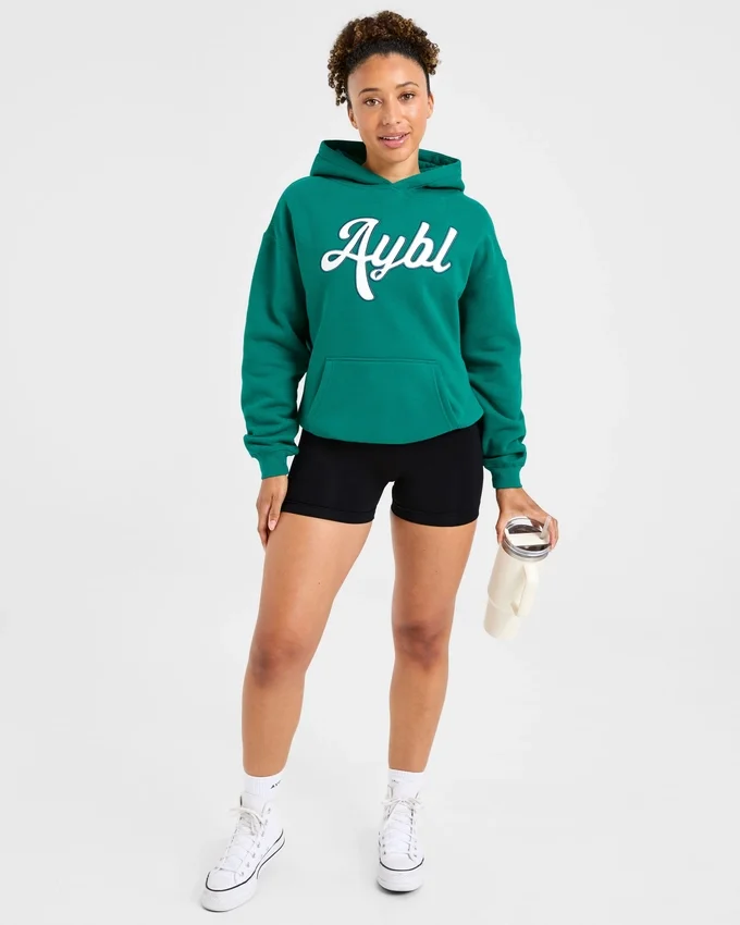 Sweat à capuche oversize avec inscription brodée