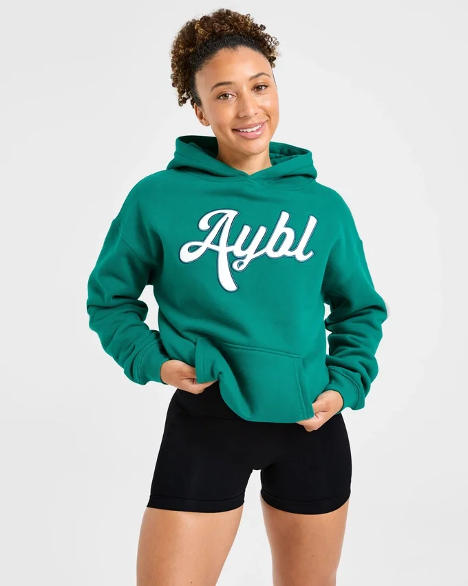 Sweat à capuche oversize avec inscription brodée